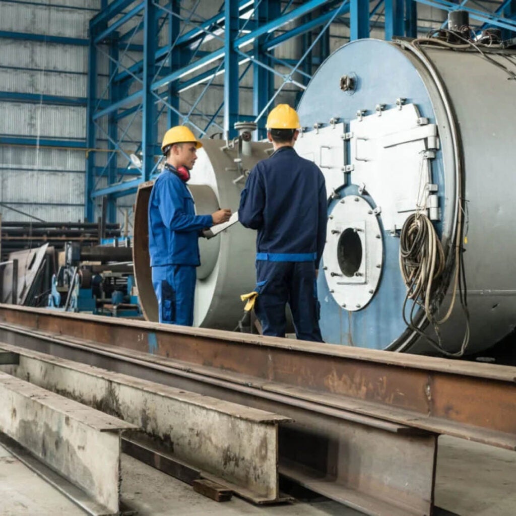 People working on a manufacturing floor.