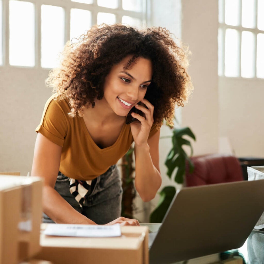 Woman on phone and laptop