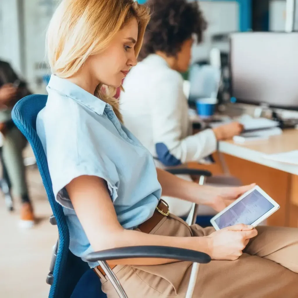 Woman using a table at her desk.